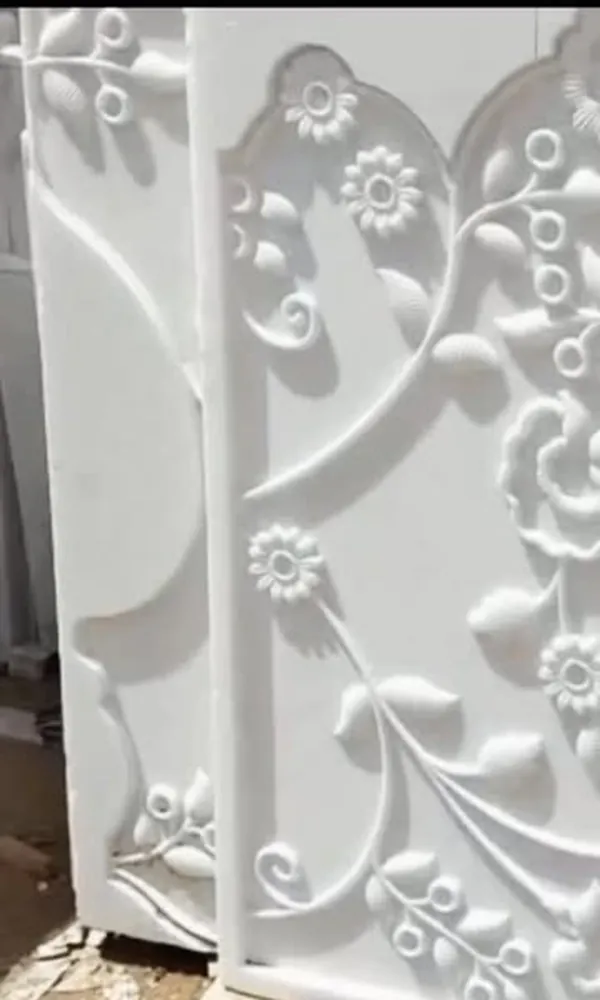 Hand-carved white marble relief panel with floral scrollwork